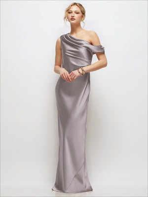 Draped one-shoulder bias stretch satin maxi dress in champagne gray with draped sleeve.