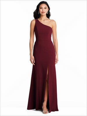 One-shoulder bridesmaid dress in burgundy with front slit, floor-length, sleeveless.