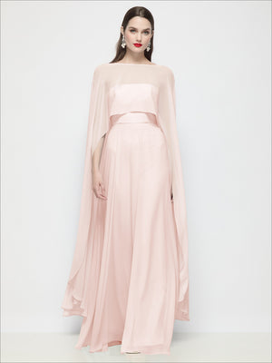 High-low sheer chiffon cape in blush pink with flowing drape and wide sleeves.