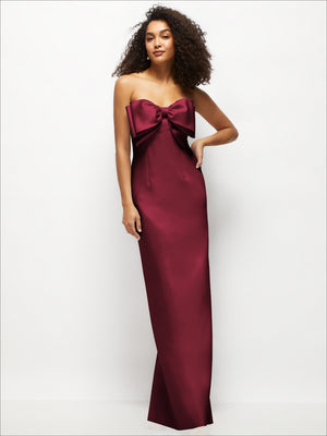 Strapless satin column maxi dress with oversized bow detail, deep burgundy color