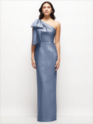 Periwinkle one-shoulder satin column maxi dress with oversized bow on the shoulder.