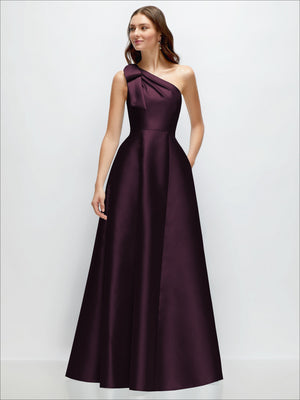 Burgundy one-shoulder satin maxi dress with draped bow detail and flowing A-line skirt.