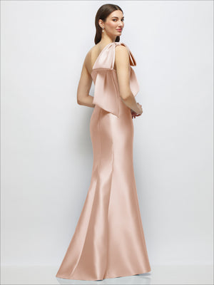 Blush one-shoulder satin maxi dress with large back bow drape and trumpet skirt