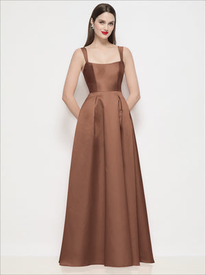 Espresso satin maxi dress with shaped basque bodice, spaghetti straps, and pleated skirt.