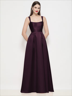 Burgundy satin maxi dress with thin straps, square neckline, fitted basque waist, pleated skirt