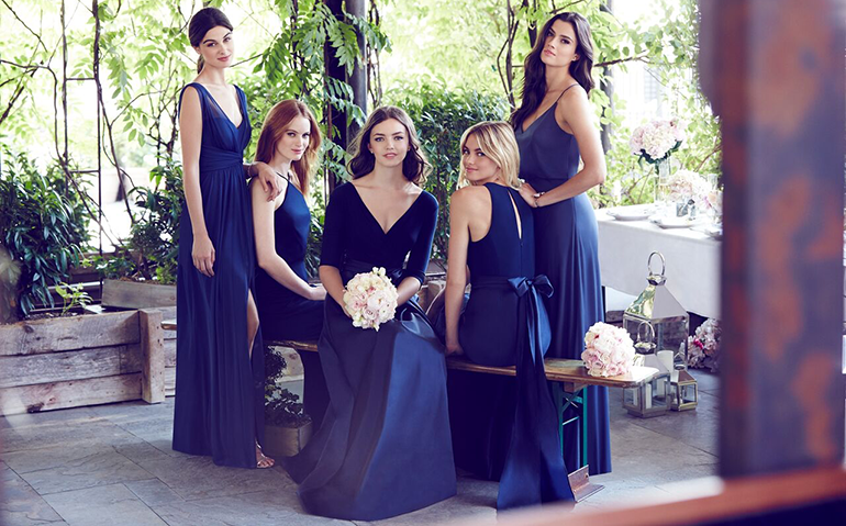 https://dessy.com/blog/image.axd?picture=/Blogs/Wedding%20Day%20Essentials/bridesmaids-wearing-royal-purple-dresses.png