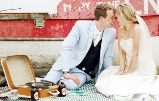 bride and groom with vintage record player 