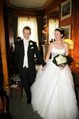 bride and groom with white rose buttonhole and white rose bouquet