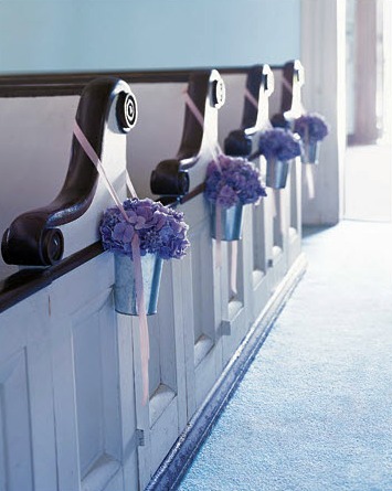 Blue hydrangeas decorating wedding pews
