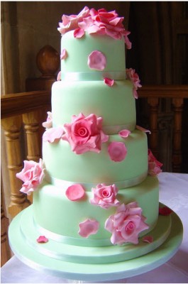 green tiered wedding cake with pink flowers