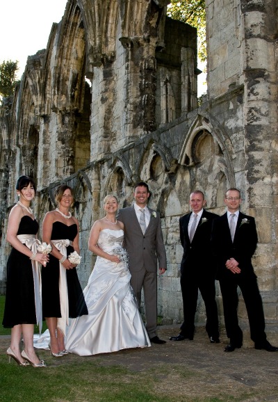 bridal party photographed by romantic ruin