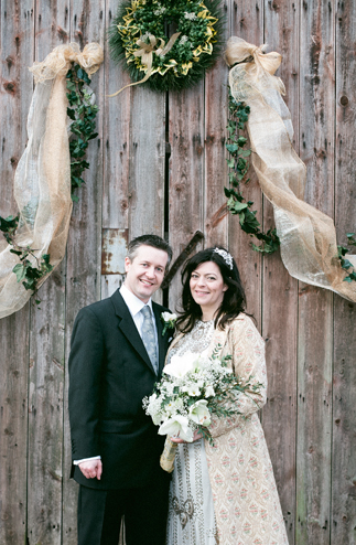 bride and groom outside wooden barn doors