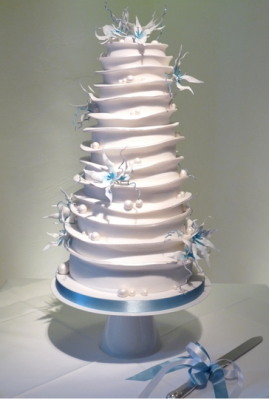white tiered wedding cake with blue flowers