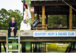 bride and groom on dock of bay