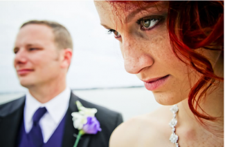 bride and groom with purple flower buttonhole