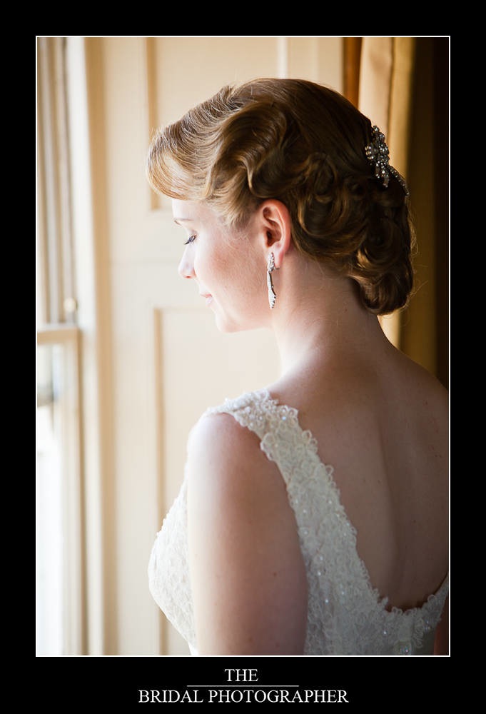 Bride with 1930's style hair and lace wedding dress