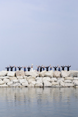 wedding guests standing by lake 