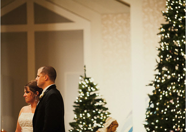 Couple with Christmas trees at January wedding