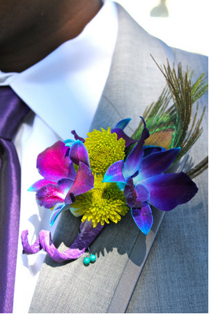 Groom buttonhole with peacock wedding theme 