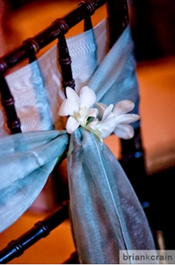 purple sash chair backs with white freesias 