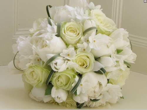 an all white spring wedding bouquet with roses 