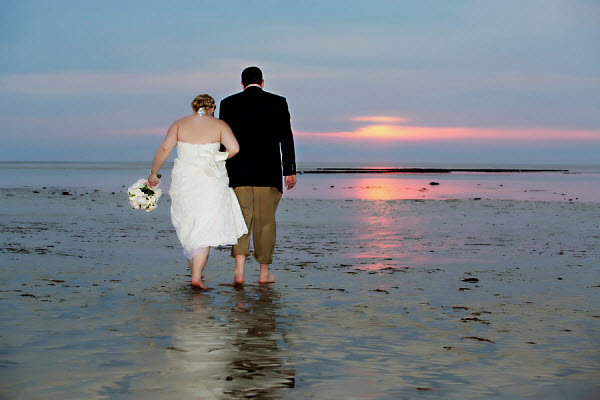 bride and groom with beach sunset
