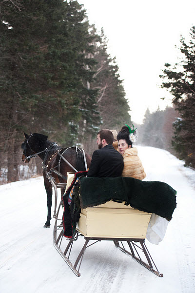 bride and groom in snow and carriage