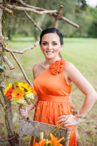 bridesmaid at orange themed wedding