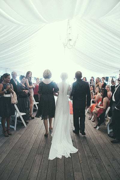 bride and parents walking down aisle