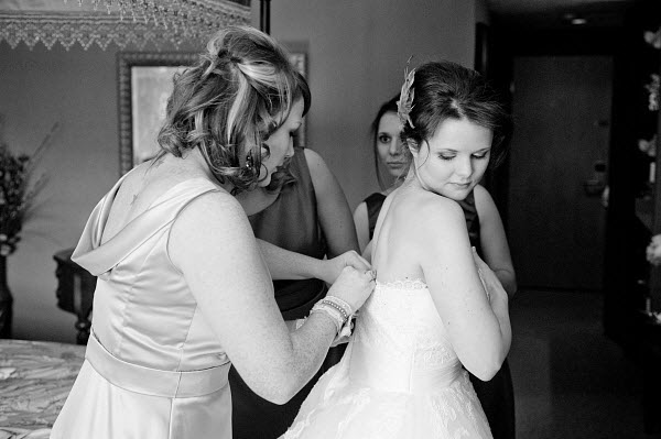 bridesmaids helping bride get ready