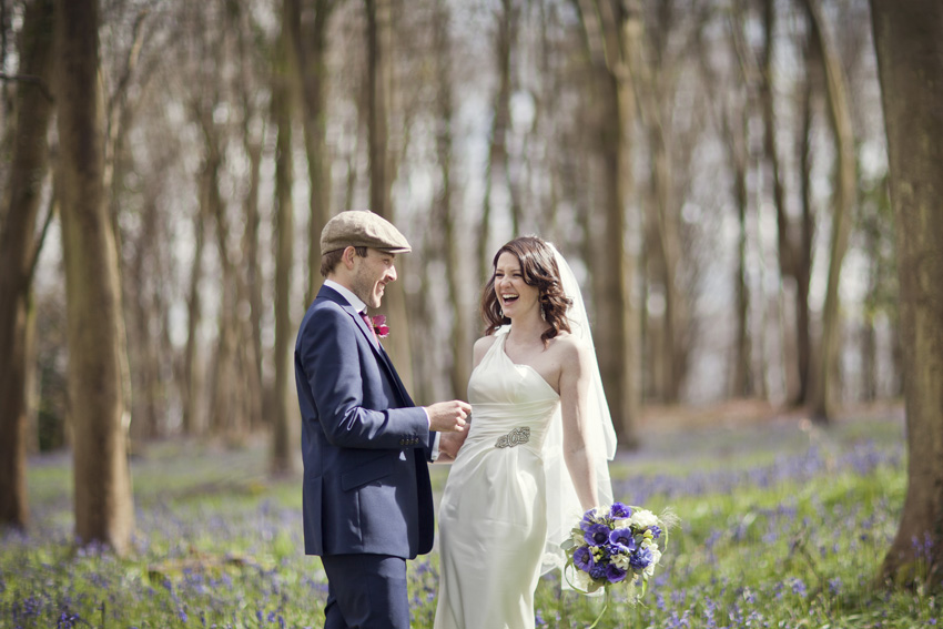 bride and groom in bluebell woods