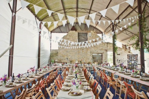 rustic wedding table setting in barn