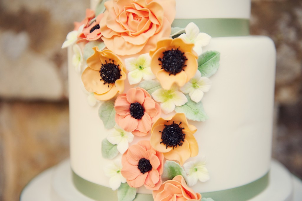 wedding cake decorated with coral and peach colours