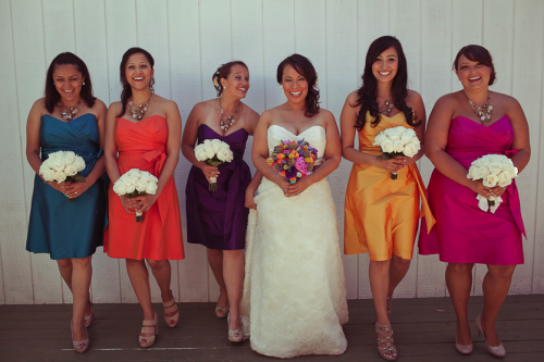 bridesmaids in multi coloured dresses