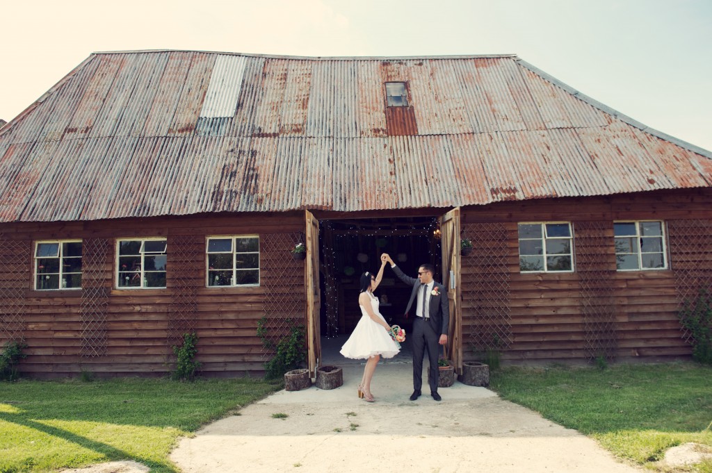 bride and groom outside rustic barn