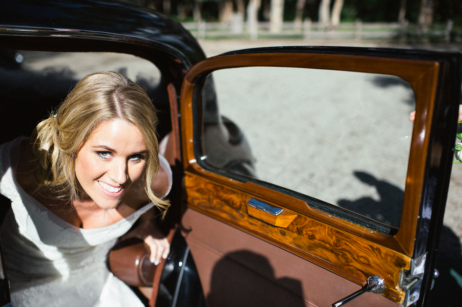 Bride getting out of car for wedding ceremony 