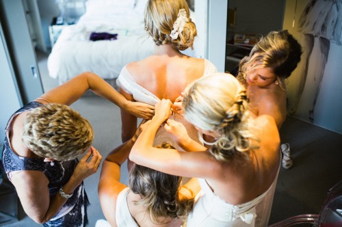 bride getting ready for wedding day with bridesmaids