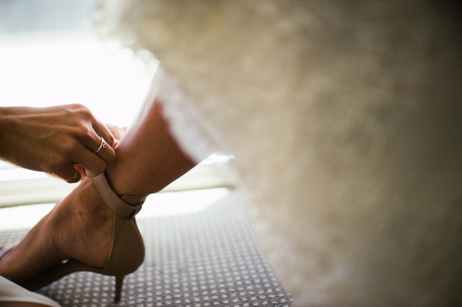 Bride putting on shoes 