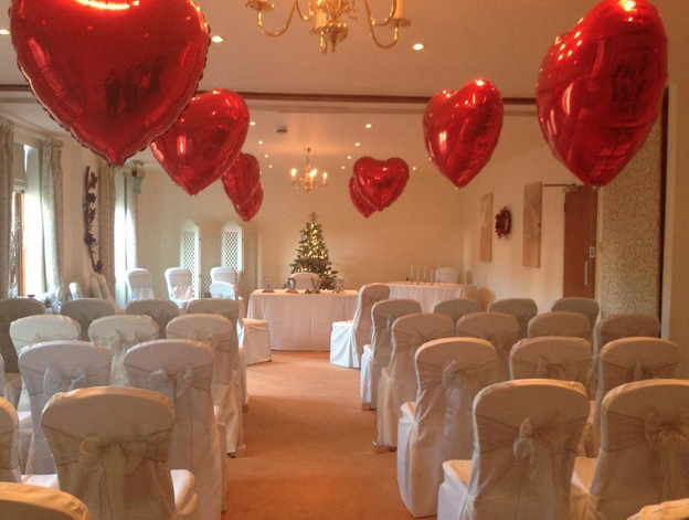 red balloons lining wedding aisle